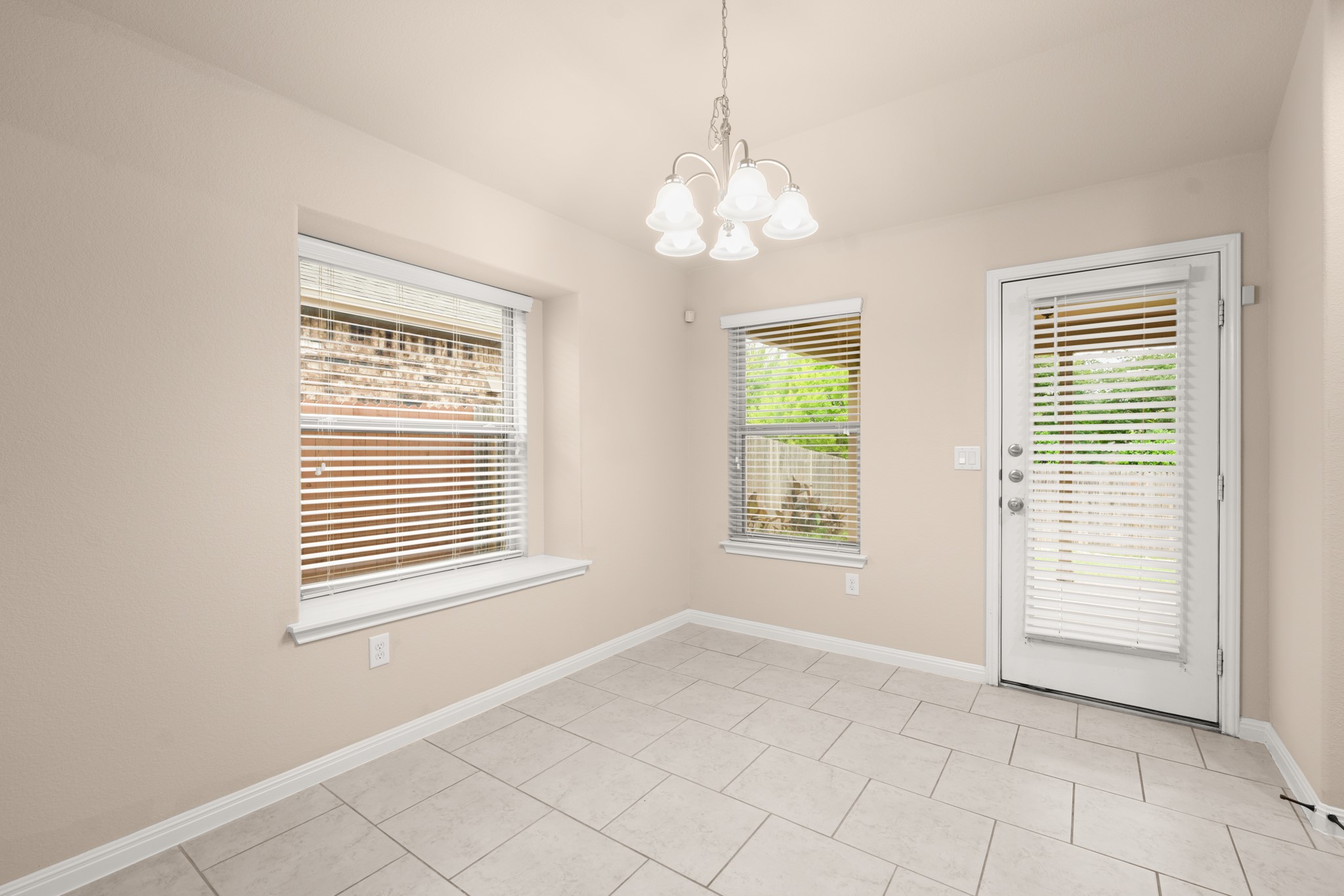 305 Longhorn Cavern Road Leander, TX 78641 - Photo 8 of 21 This bright breakfast nook is the perfect spot for morning coffee, featuring easy-to-clean tile and direct access to the backyard.