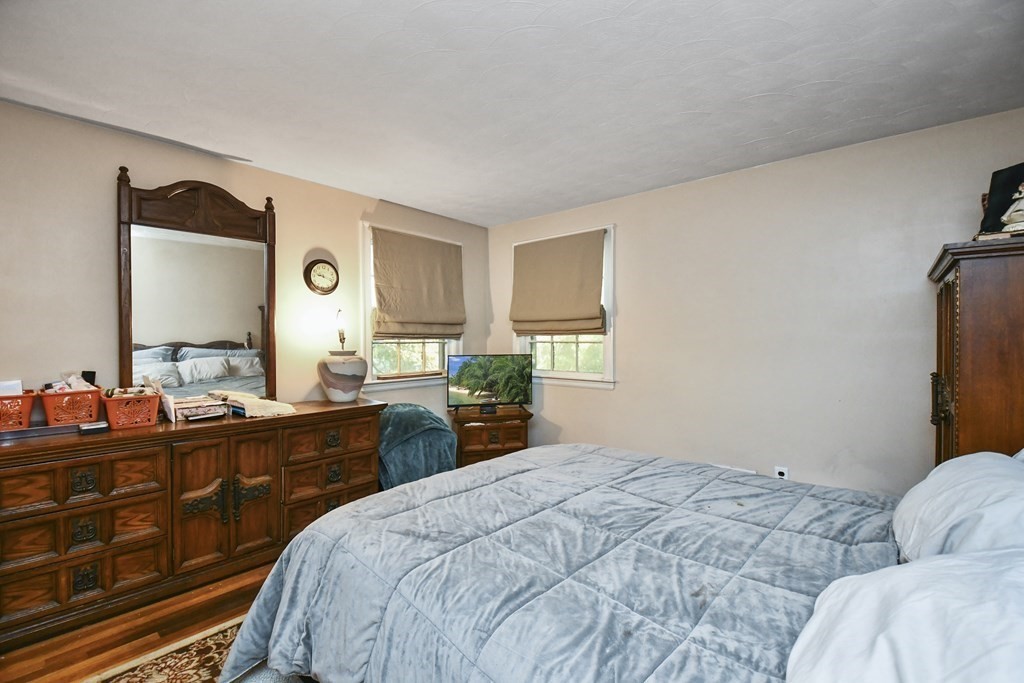 57 Davidson Road Framingham, MA 01701 - Photo 11 of 28 a bedroom with a bed and a dresser in it