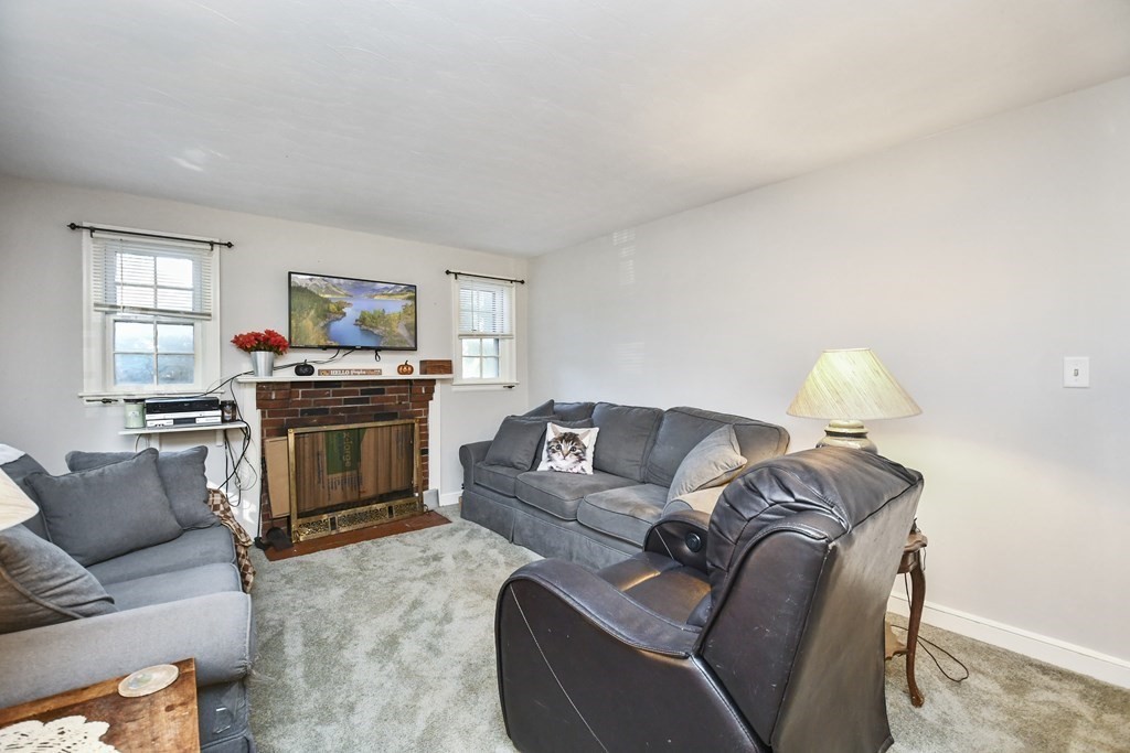 57 Davidson Road Framingham, MA 01701 - Photo 2 of 28 a living room with furniture and a fireplace