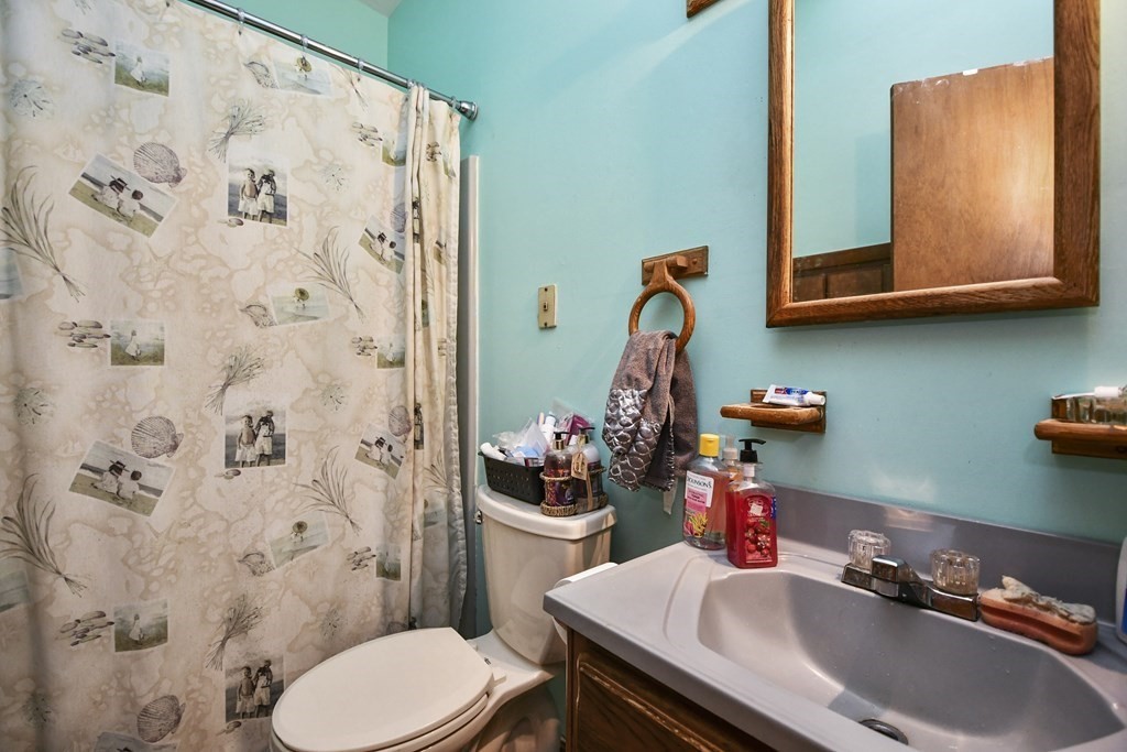 57 Davidson Road Framingham, MA 01701 - Photo 21 of 28 a bathroom with a sink a toilet and shower curtain