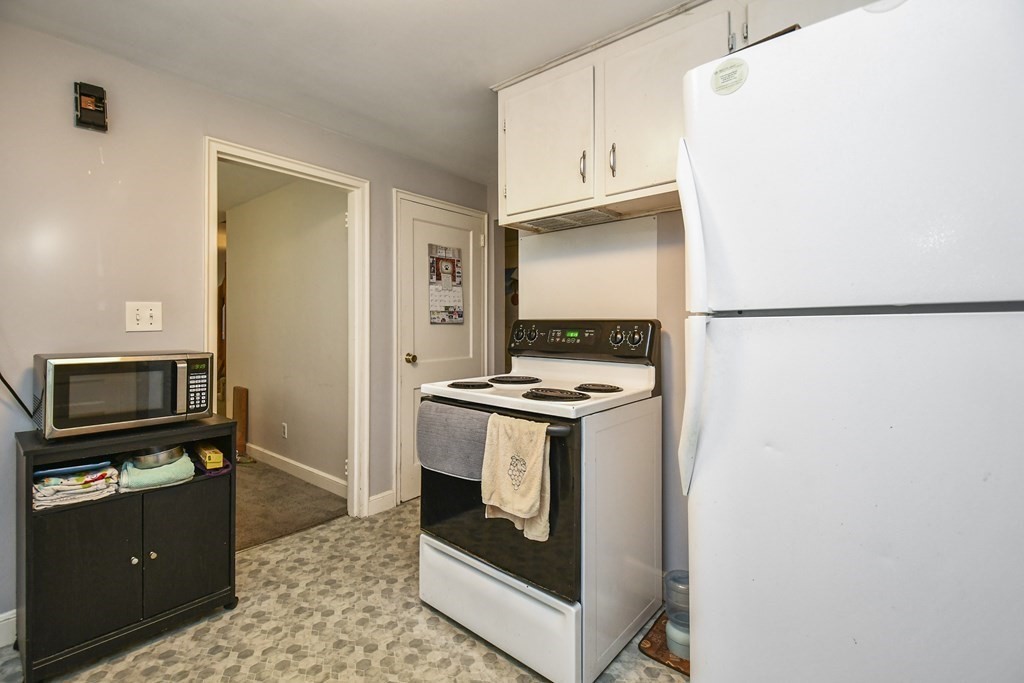 57 Davidson Road Framingham, MA 01701 - Photo 8 of 28 a kitchen with stainless steel appliances granite countertop a refrigerator and a stove