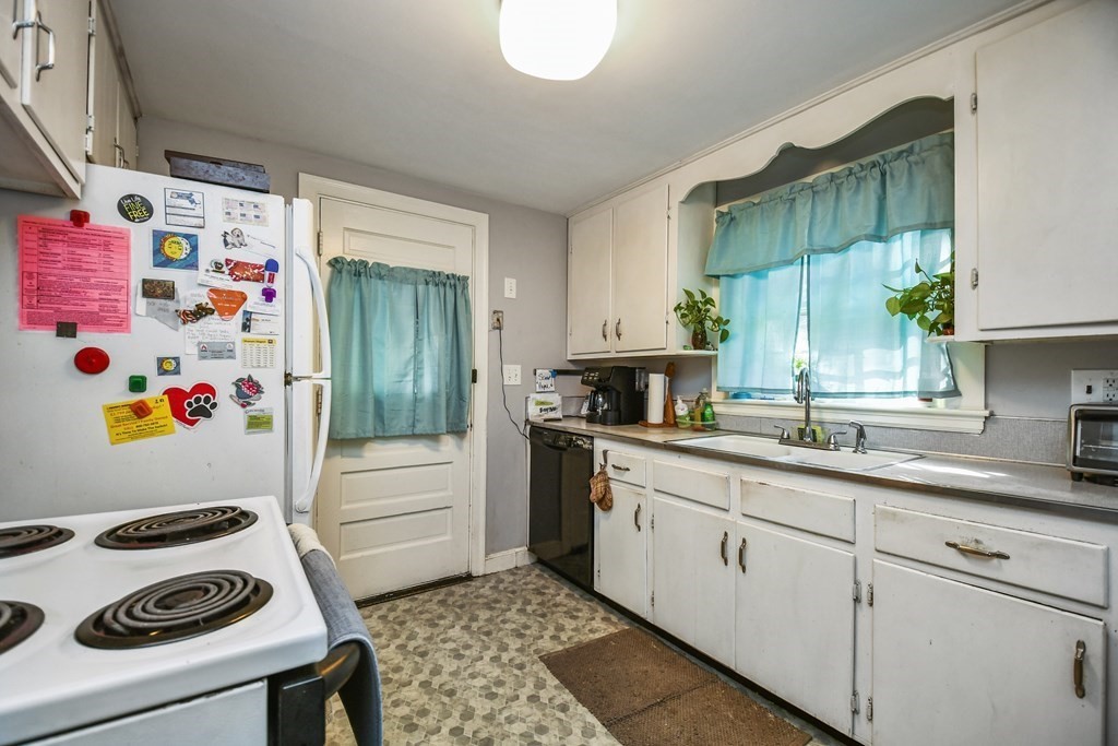 57 Davidson Road Framingham, MA 01701 - Photo 10 of 28 a kitchen with a refrigerator a stove a sink and a window