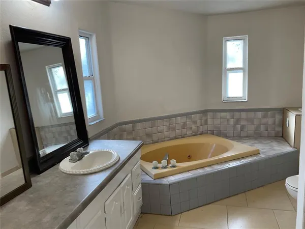 a bath tub sitting next to a bathroom sink
