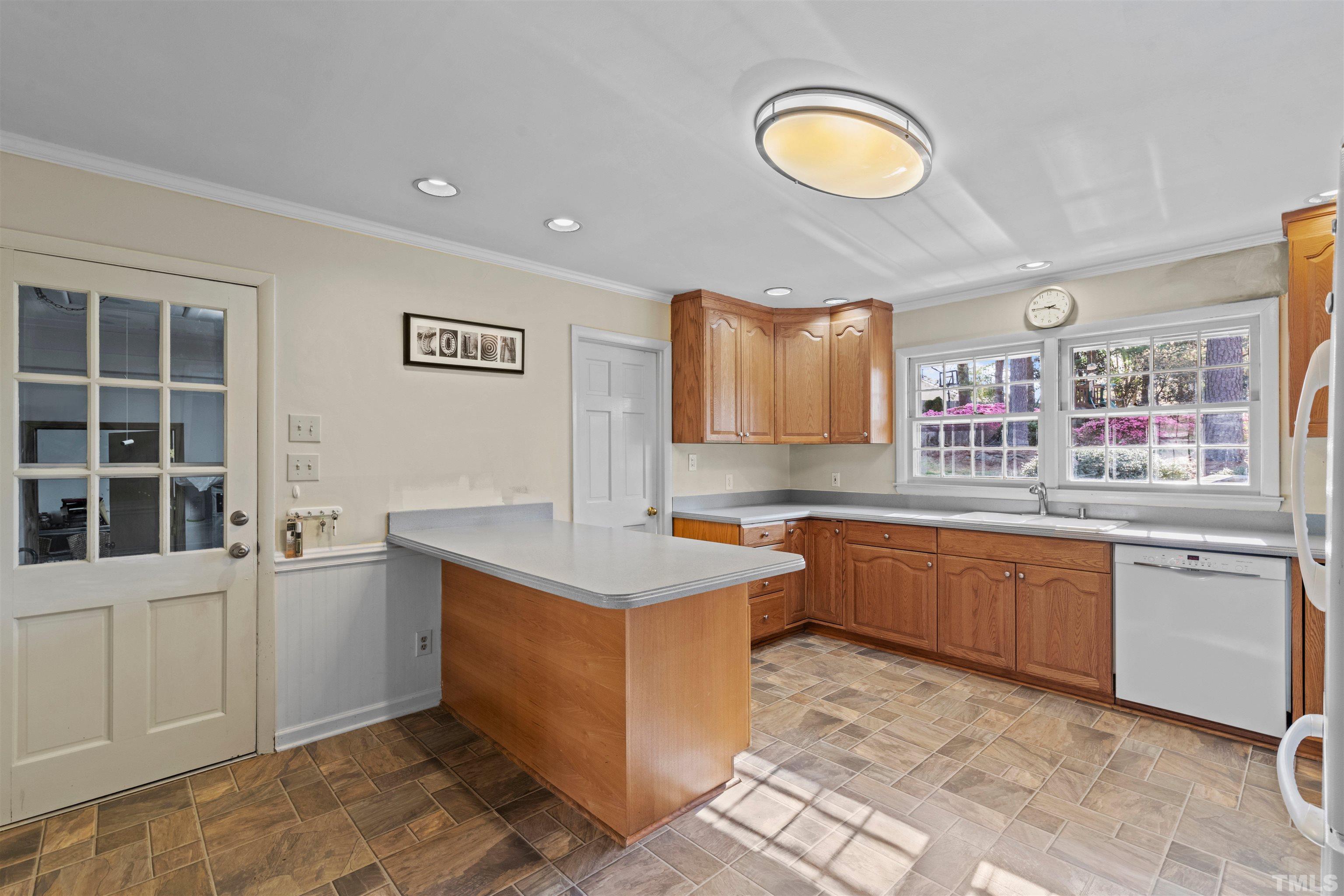 6000 Buffaloe Road Raleigh, NC 27616 - Photo 16 of 36 a kitchen with a stove a sink and a window