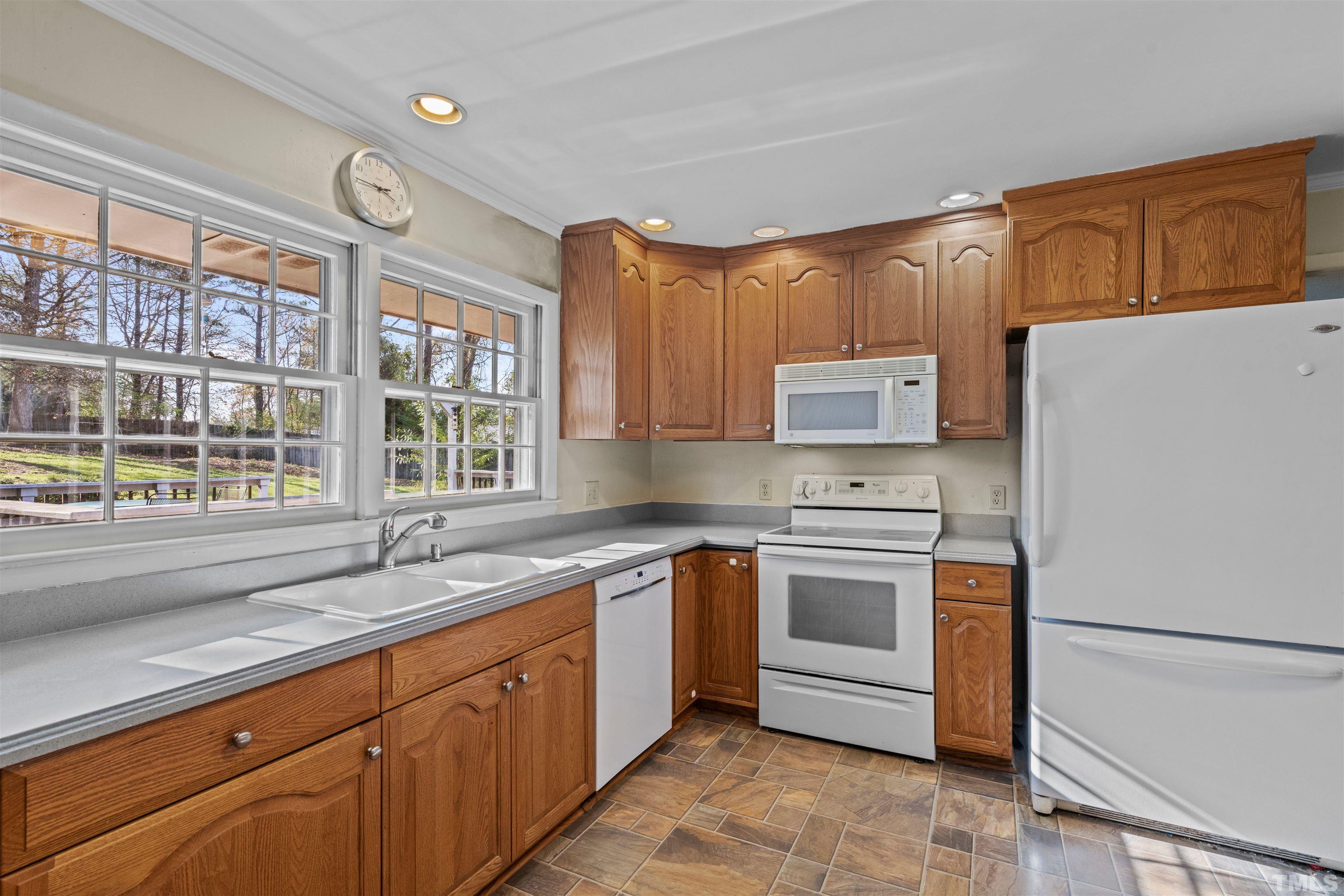 6000 Buffaloe Road Raleigh, NC 27616 - Photo 17 of 36 a kitchen with a stove a sink and a refrigerator