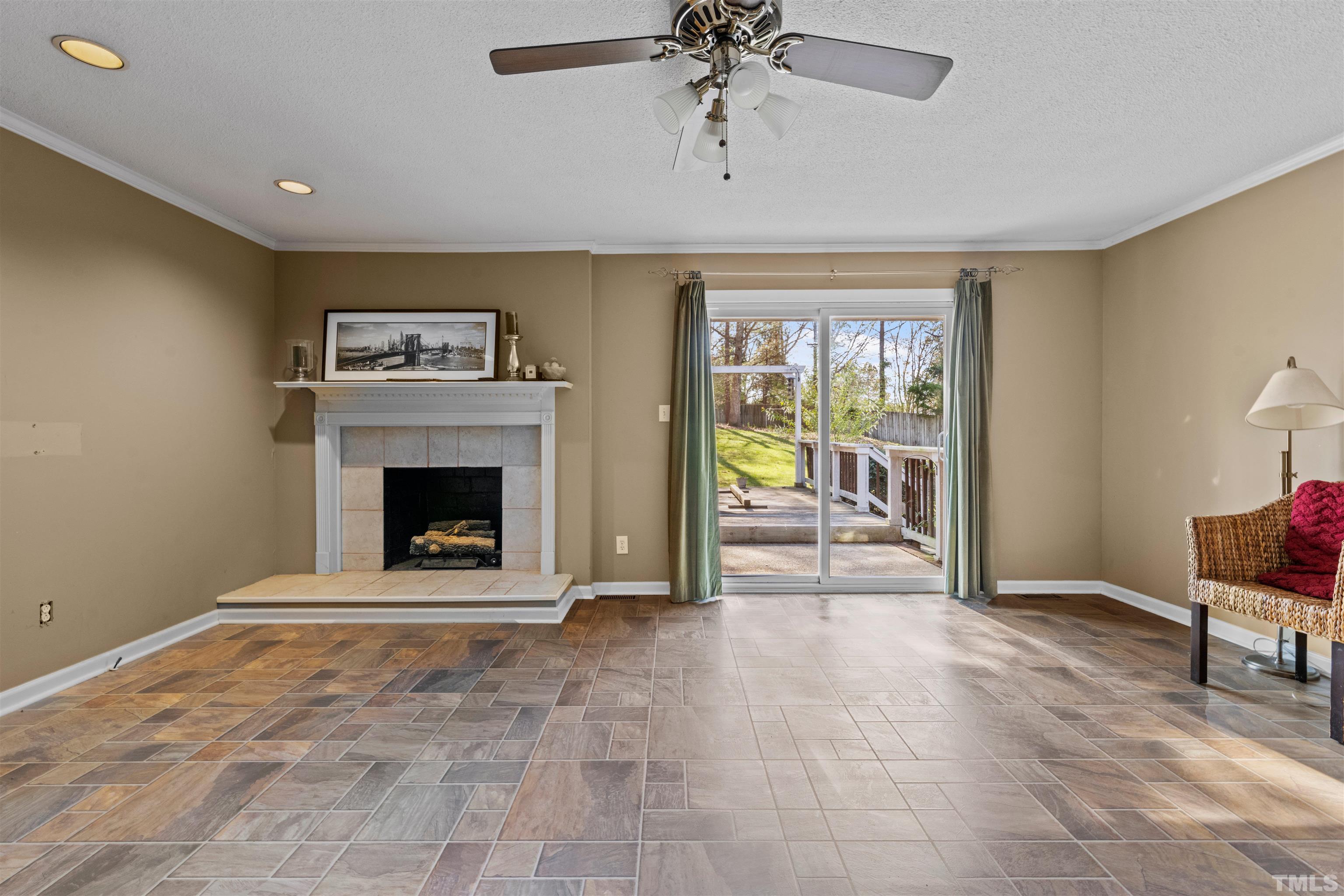 6000 Buffaloe Road Raleigh, NC 27616 - Photo 19 of 36 a view of an empty room with a fireplace and a window
