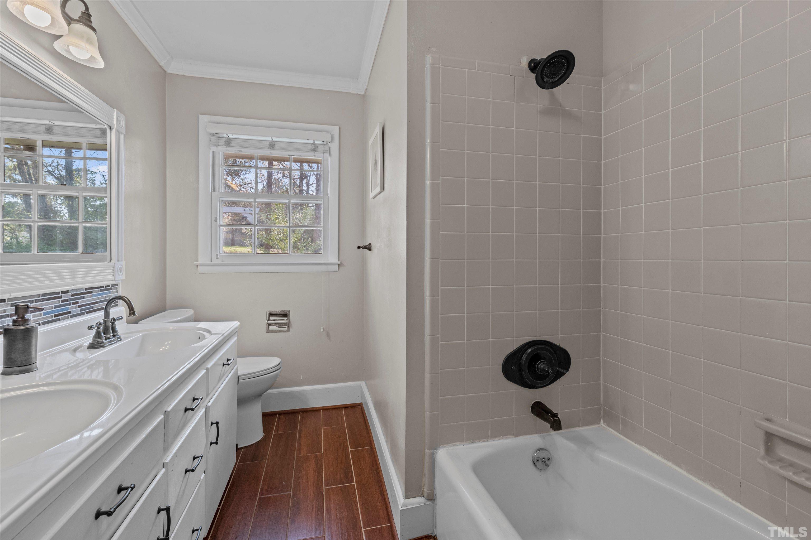 6000 Buffaloe Road Raleigh, NC 27616 - Photo 24 of 36 a bathroom with a tub a sink a window and a shower