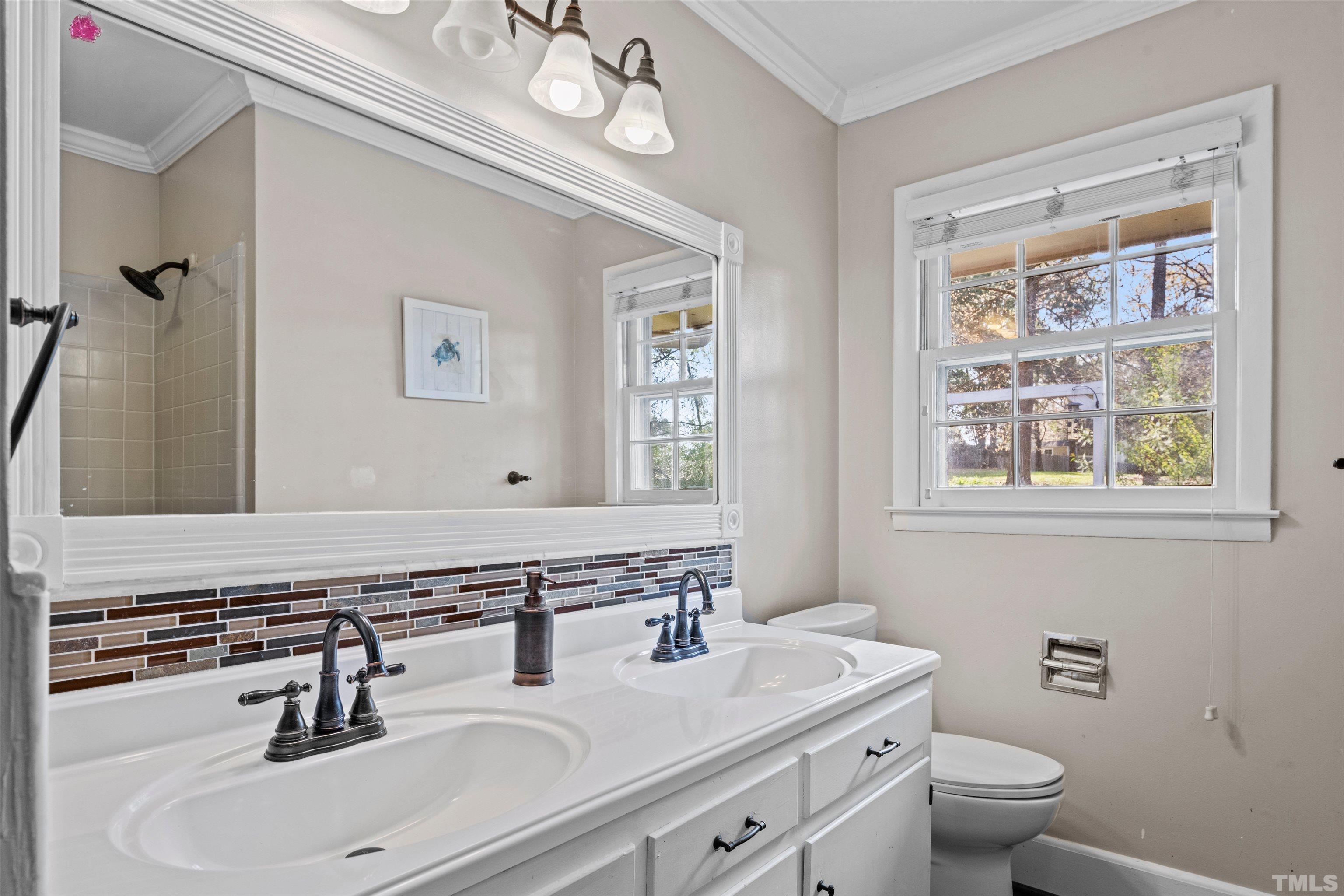 6000 Buffaloe Road Raleigh, NC 27616 - Photo 25 of 36 a bathroom with a sink a toilet and a mirror