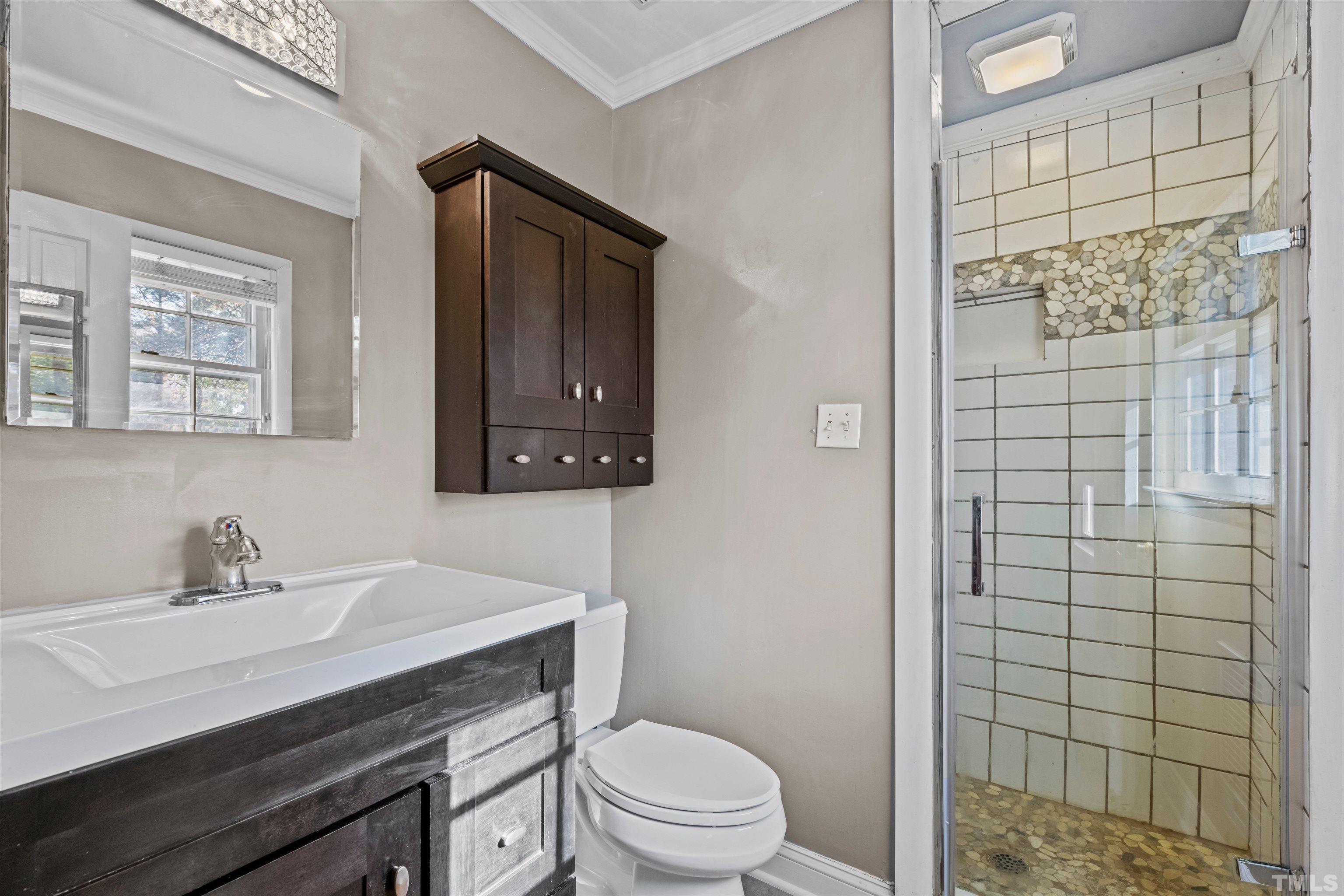 6000 Buffaloe Road Raleigh, NC 27616 - Photo 28 of 36 a bathroom with a sink a toilet and shower