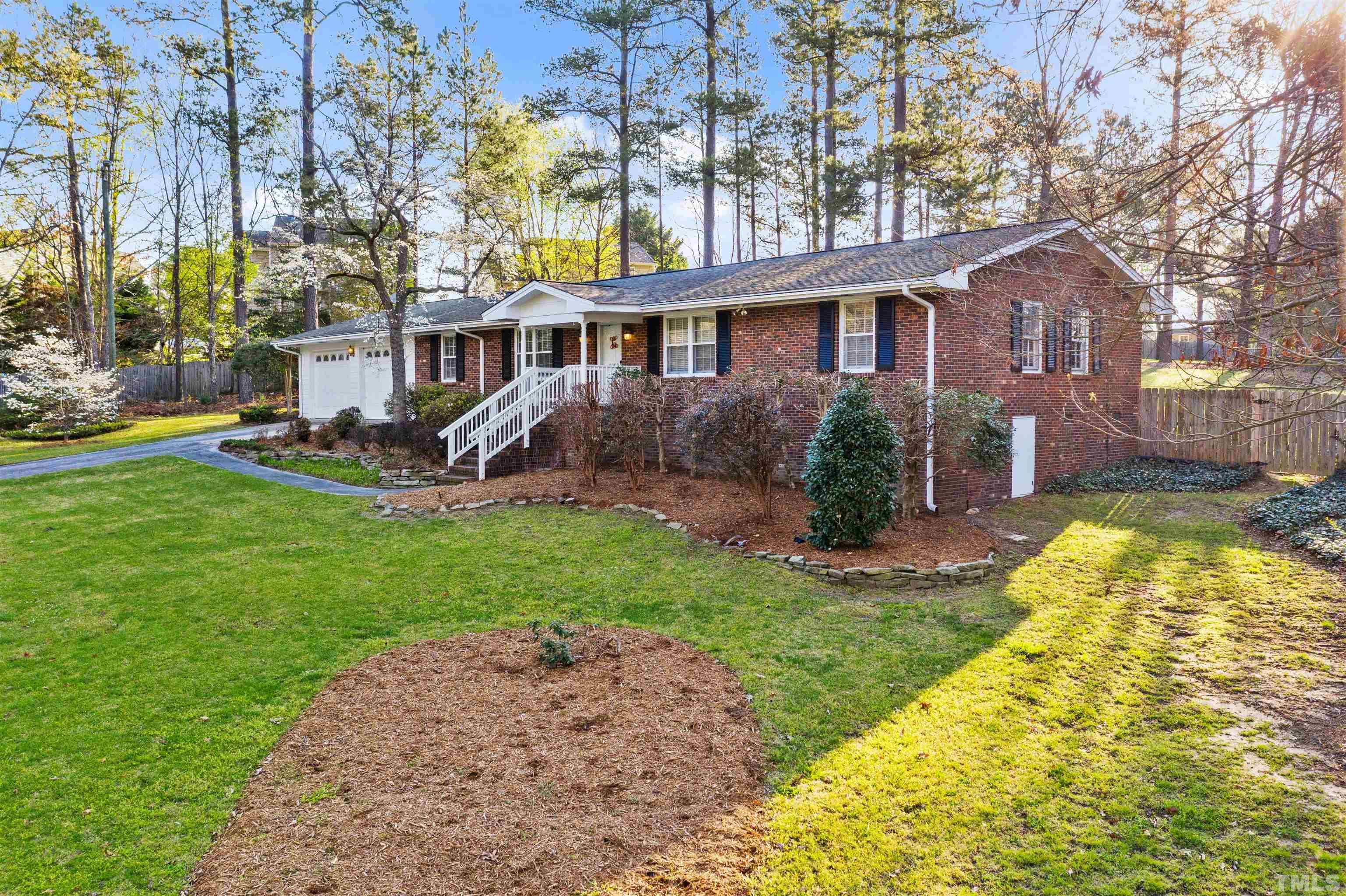 6000 Buffaloe Road Raleigh, NC 27616 - Photo 4 of 36 a front view of a house with a yard table and chairs