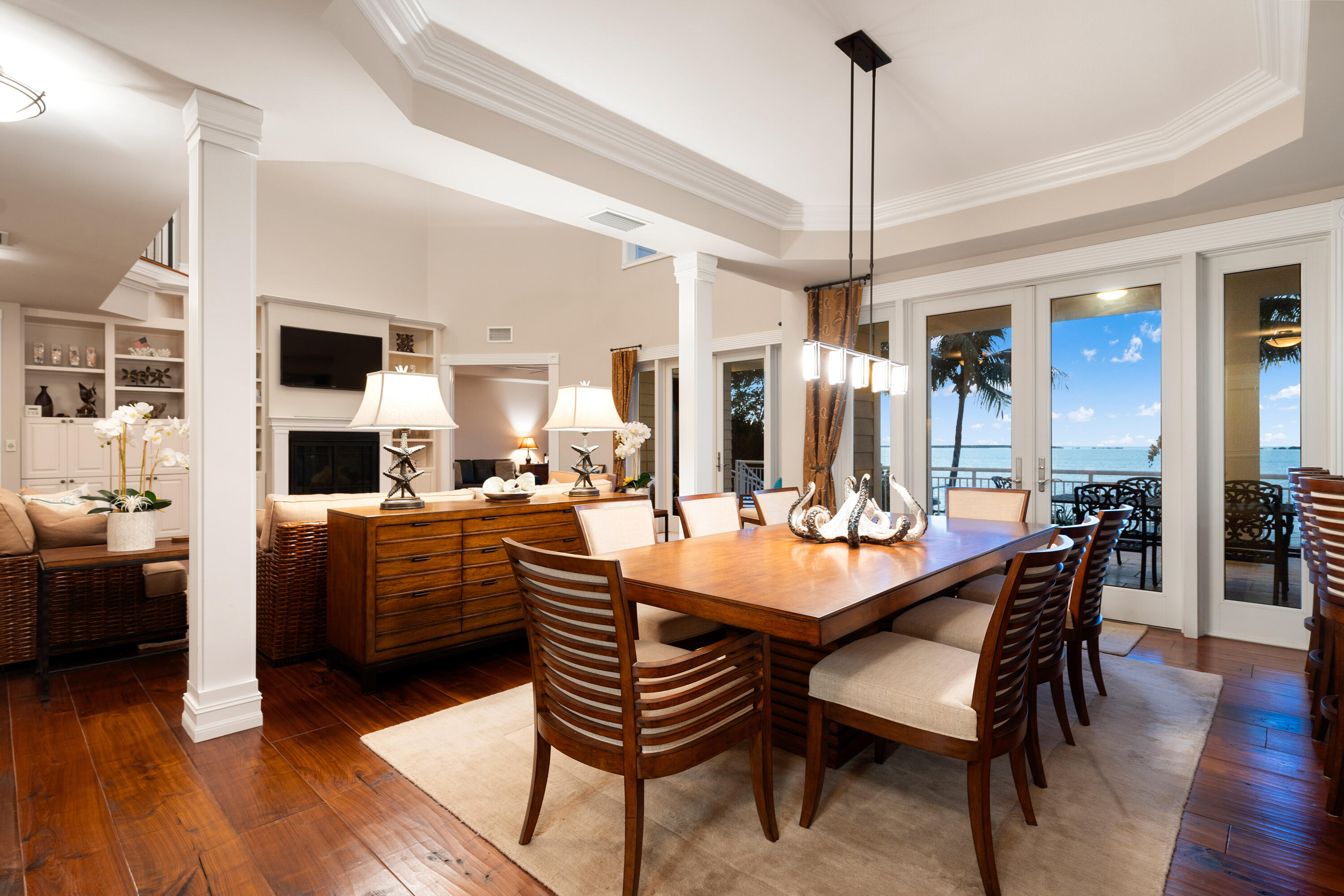 104 Coastal Drive Key Largo, FL 33037 - Photo 14 of 77 a dining room with furniture a chandelier and wooden floor