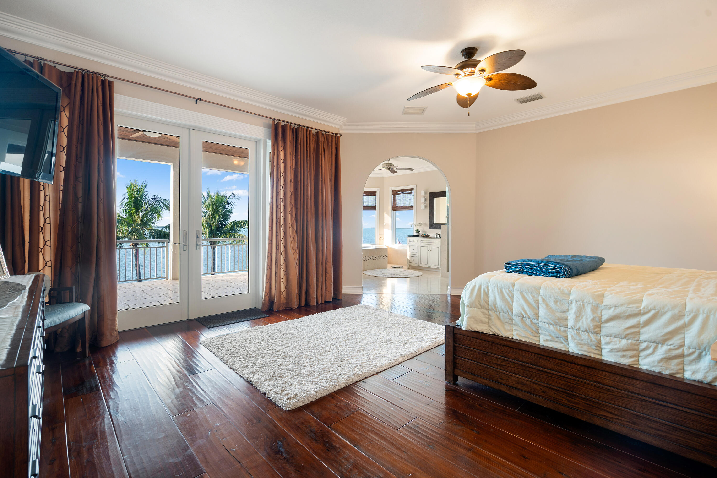 104 Coastal Drive Key Largo, FL 33037 - Photo 35 of 77 a bedroom with a bed and a chandelier