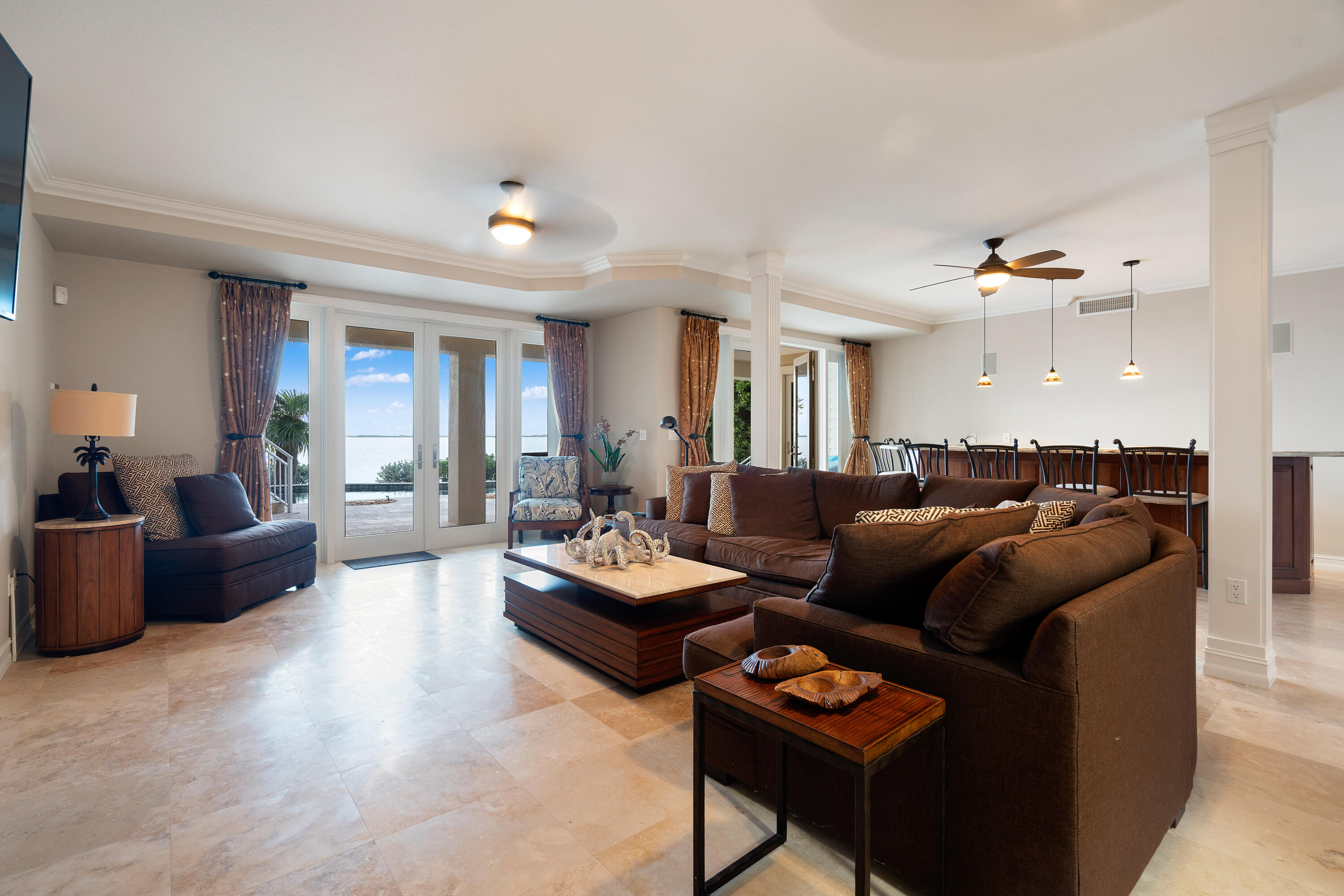 104 Coastal Drive Key Largo, FL 33037 - Photo 54 of 77 a living room with furniture a rug and a chandelier