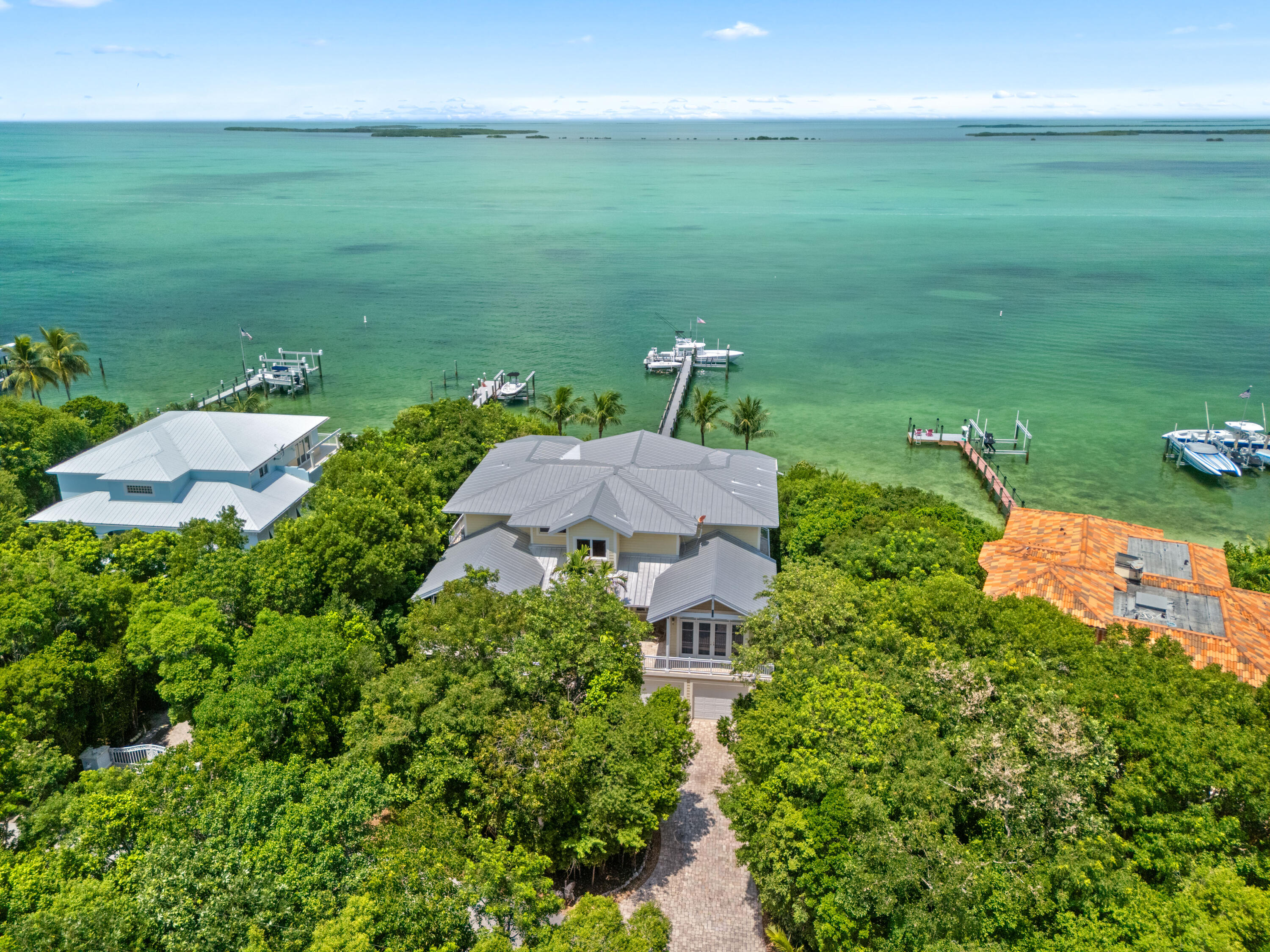 104 Coastal Drive Key Largo, FL 33037 - Photo 76 of 77 an aerial view of a houses with outdoor space and trees all around