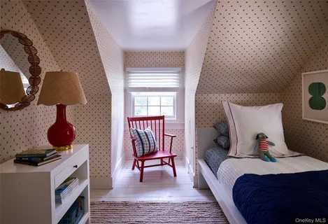 a bed room with a bed and a chair