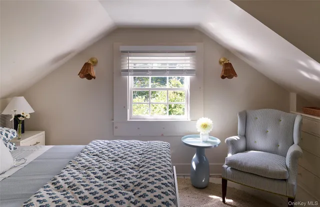 a bedroom with furniture and a window