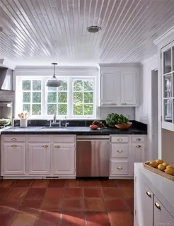 a kitchen with granite countertop a stove a sink and dishwasher wooden cabinets with granite countertops