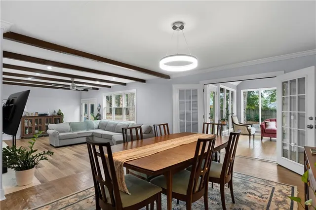 a view of a dining room with furniture and a large window