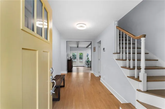 a view of entryway and hall with wooden floor