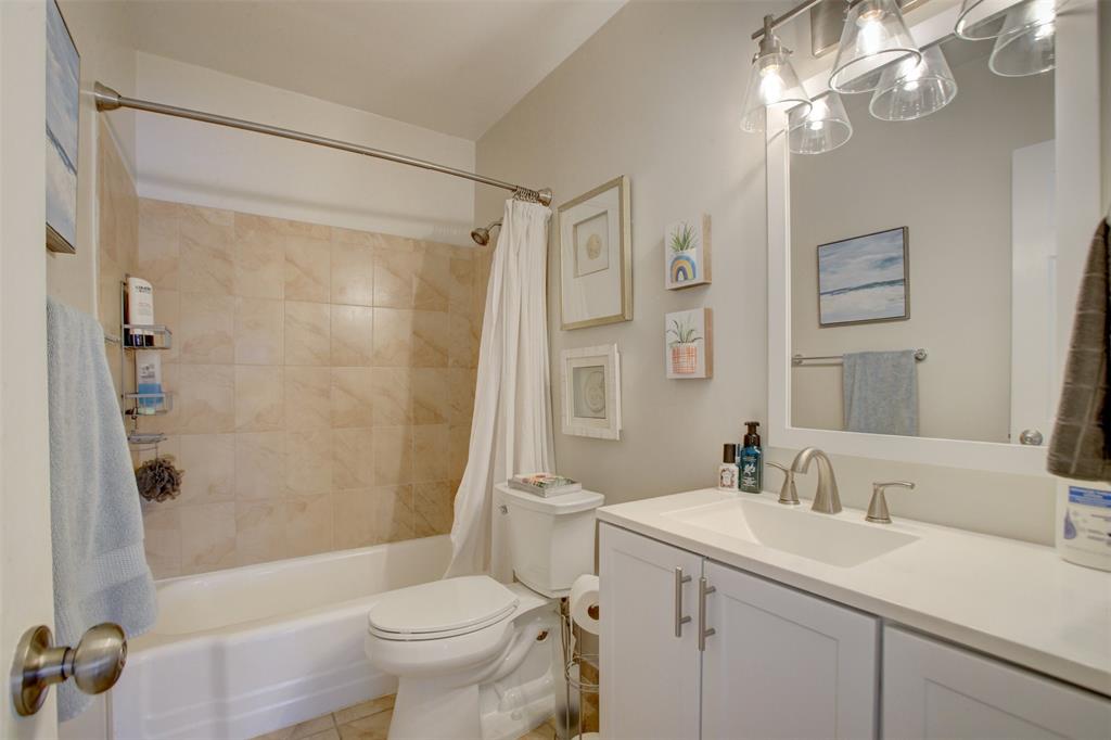 999 North Riverside Drive, Unit 10 Pompano Beach, FL 33062 - Photo 11 of 14 a bathroom with a sink a toilet and a mirror