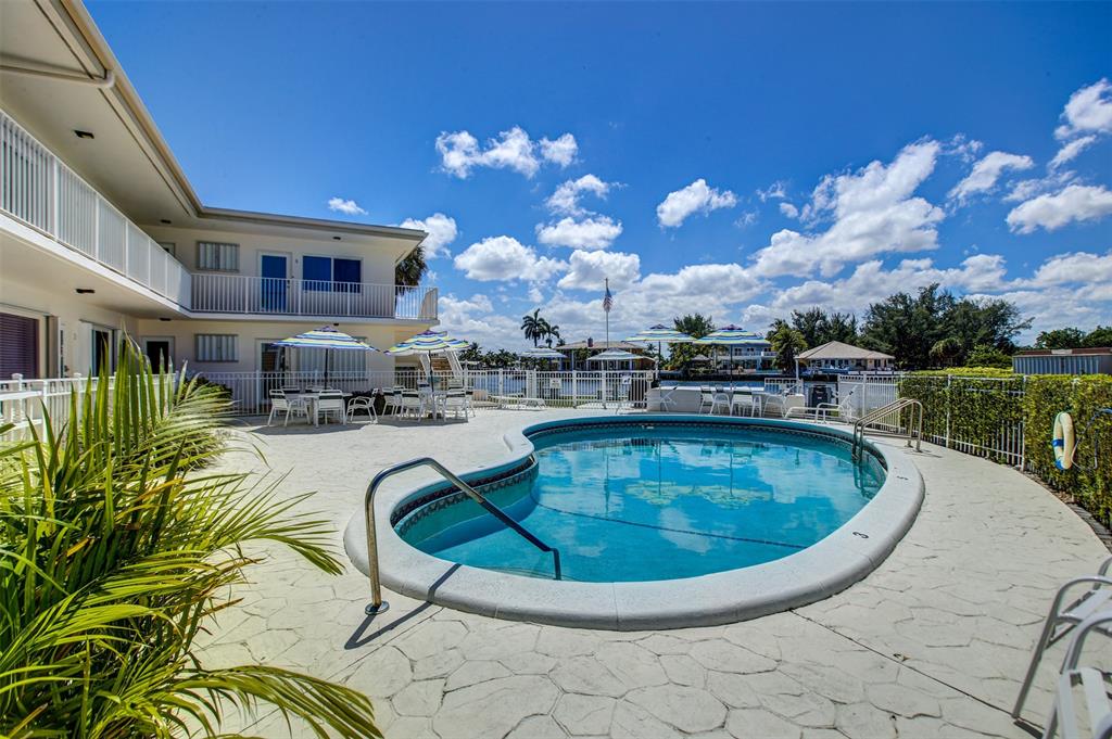 999 North Riverside Drive, Unit 10 Pompano Beach, FL 33062 - Photo 13 of 14 a view of a swimming pool with outdoor seating