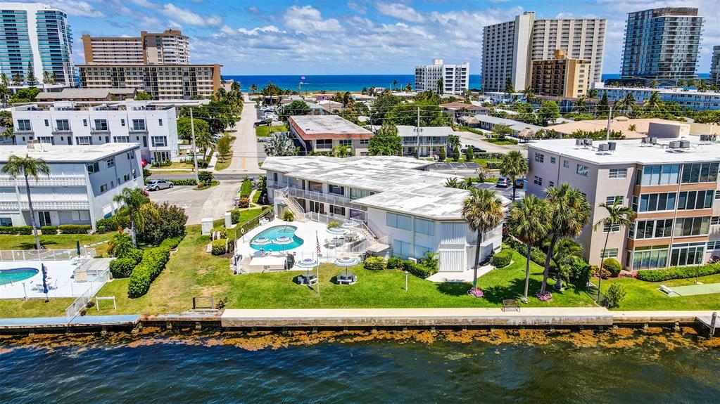 999 North Riverside Drive, Unit 10 Pompano Beach, FL 33062 - Photo 2 of 14 a view of building with outdoor space and seating space