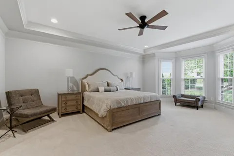 a spacious bedroom with a bed a couch and a couch