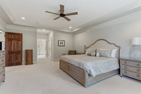 a bedroom with furniture and a flat screen tv