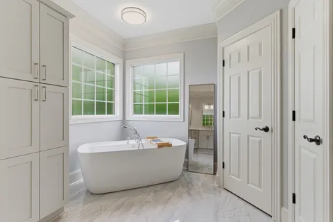 a spacious bathroom with a shower sink and mirror