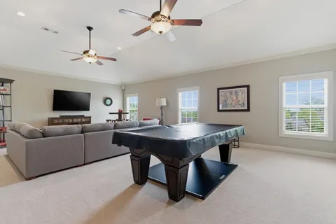 a living room with furniture a table and a potted plant
