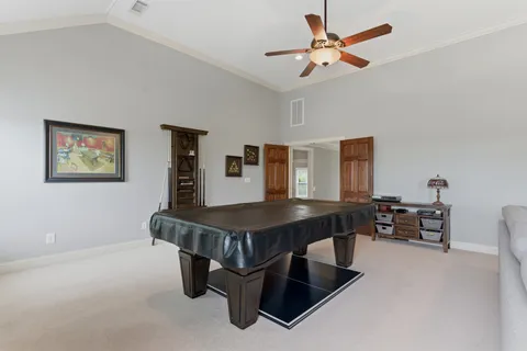 a bedroom with a bed a lamp and a flat screen tv