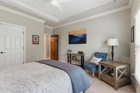 a spacious bedroom with a bed and a table in it