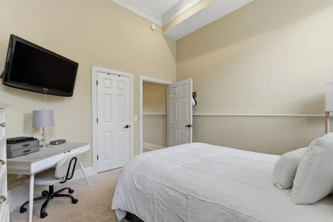 a view of a house with a big yard plants and large trees