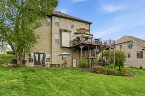 a view of a patio with table and chairs and potted plants