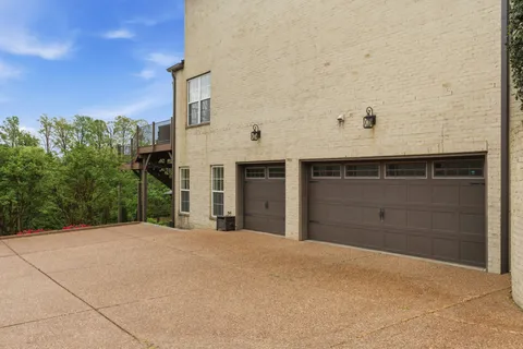 an aerial view of a house with a garden and lake view