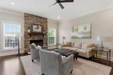 a living room with furniture and a fireplace