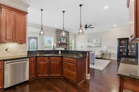 a kitchen with sink cabinets and wooden floor
