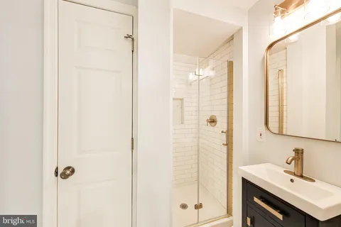 a bathroom with a shower and a sink