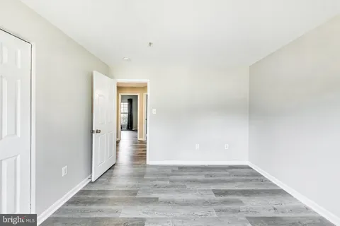 a view of an empty room and wooden floor