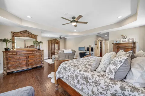 a bedroom with a bed and a computer on a desk