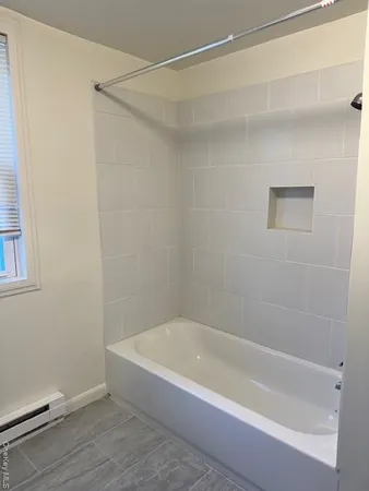 a bathroom with a bathtub and a shower