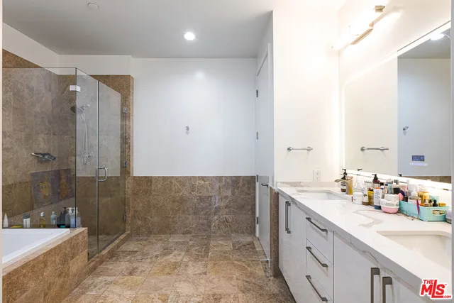 a bathroom with a tub sink and mirror