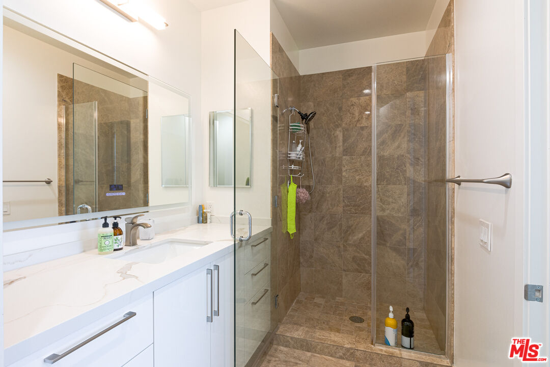 3223 West 6th Street, Unit 902 Los Angeles, CA 90020 - Photo 14 of 19 a bathroom with a shower sink and mirror