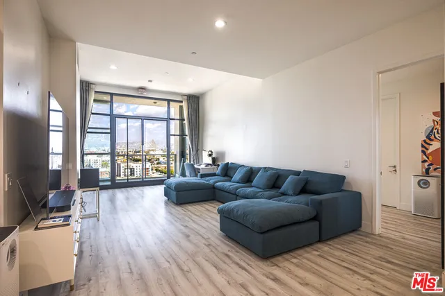a living room with furniture and a large window