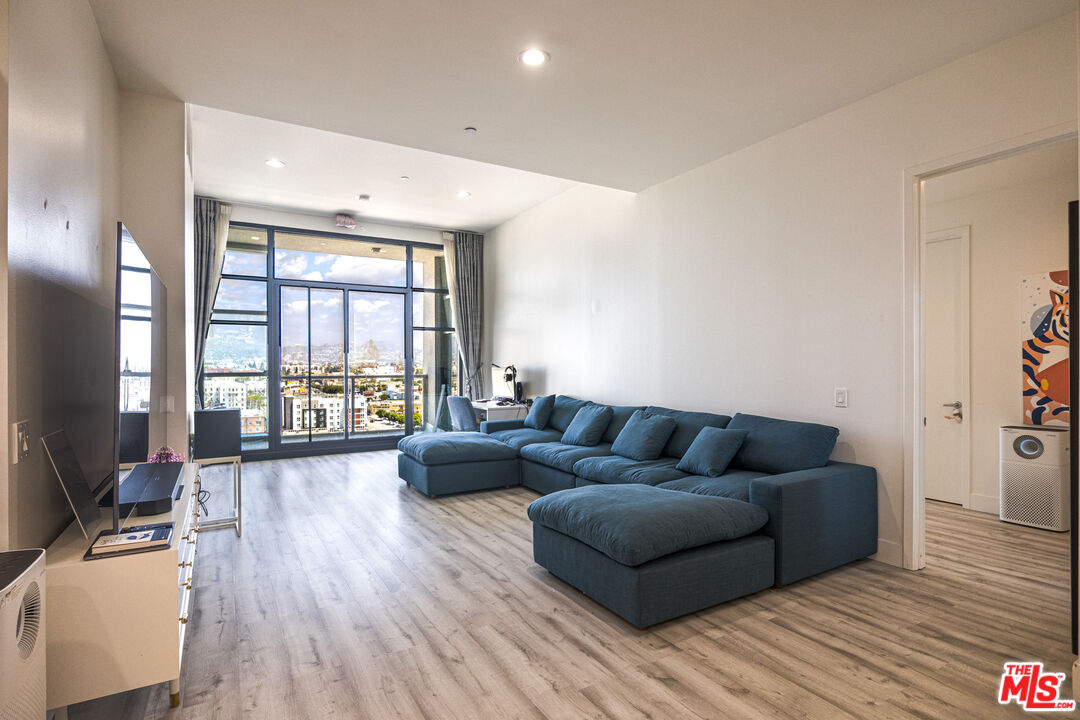 3223 West 6th Street, Unit 902 Los Angeles, CA 90020 - Photo 4 of 19 a living room with furniture and a large window