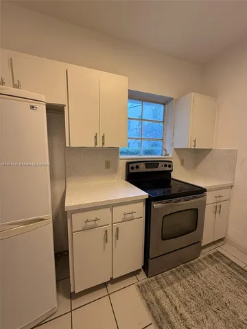 a kitchen with a stove sink and refrigerator
