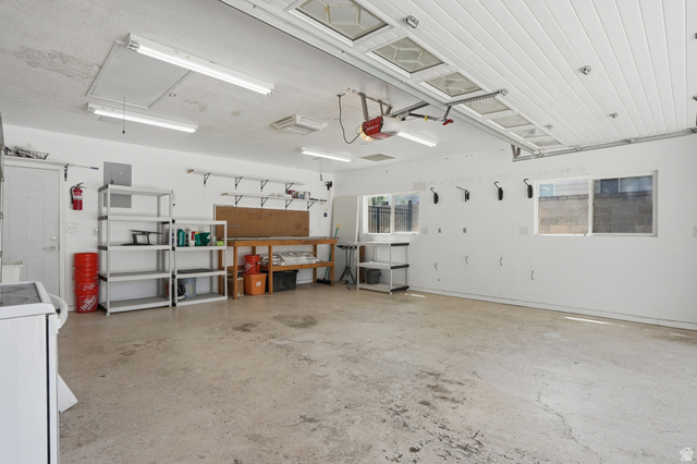 6889 South Village Road Salt Lake City, UT 84121 - Photo 26 of 44 Spacious garage featuring EV hookups, separate heating and cooling, plus a large workbench
