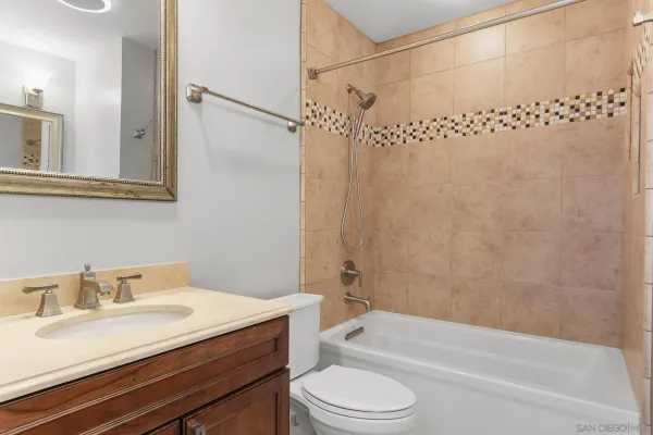 a bathroom with a sink vanity and mirror