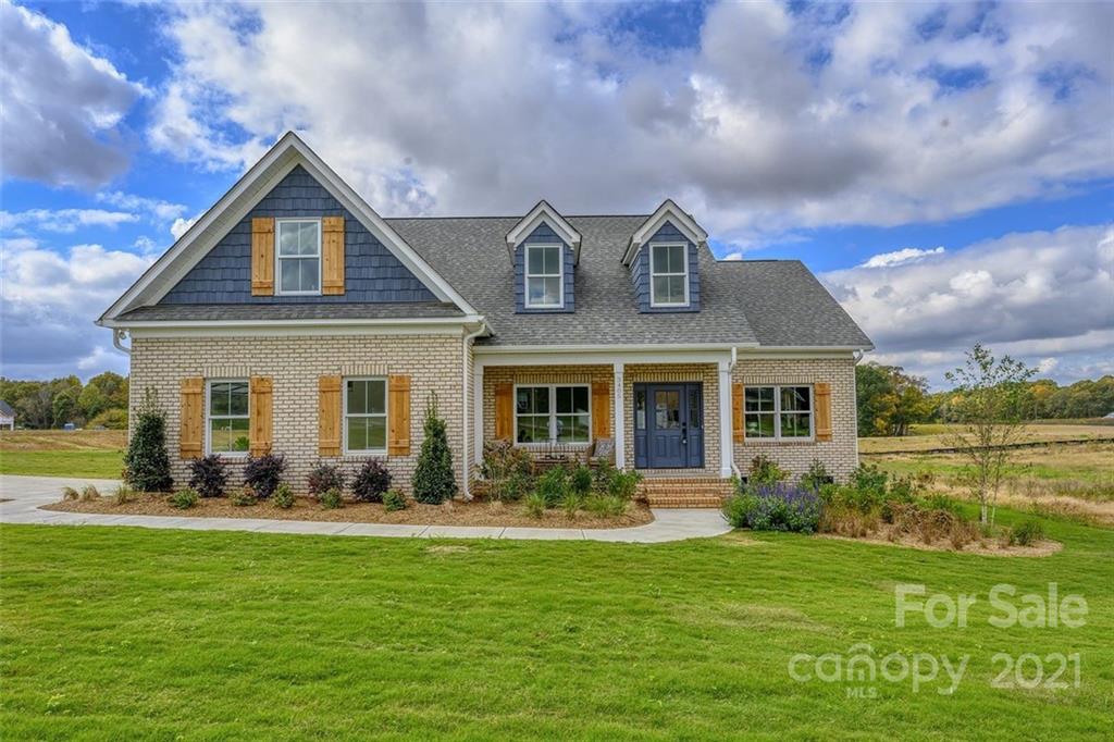 3405 Sincerity Road, Unit 14 Monroe, NC 28110 - Photo 1 of 11 a front view of a house with garden