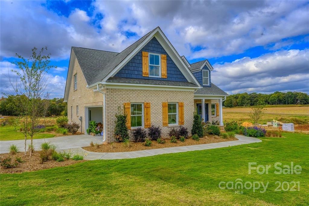 3405 Sincerity Road, Unit 14 Monroe, NC 28110 - Photo 2 of 11 a front view of a house with garden